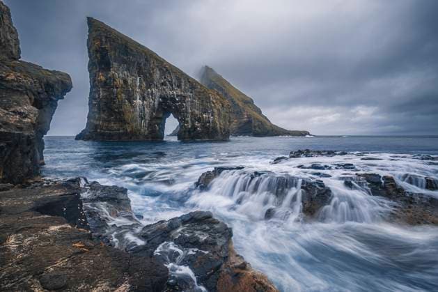 Creative Highlights World Dramatic Sea Arch of Drangarnir and waves crashing on the Faroe Islands coast, Faroe Islands, Denmark, Atlantic, Europe Copyright: FrancescoxFanti 1336-1203 RECORD DATE NOT STATED