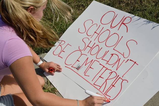 September 4, 2024, Winder, Georgia, USA: GRETCHEN GERLACH writes a sign that reads Our Schools Shouldn™t Be Cemeteries in front of Apalachee High School. Two students and two teachers were killed and nine people were injured in the shooting at Apalachee High School Wednesday, authorities said. Winder USA  - ZUMA 20240904_new_o124_004 Copyright: xChristopherxOquendox