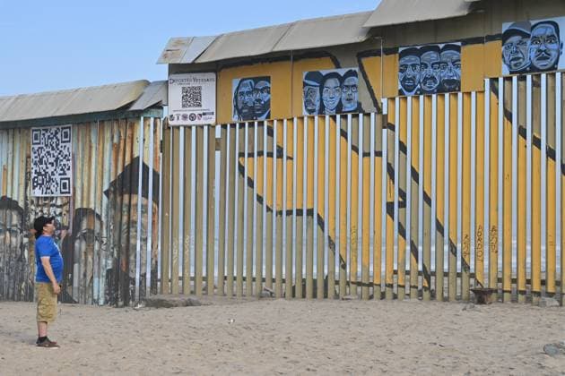 September 6, 2024, Tijuana, Baja California, Mexico: A man looks at a new interactive mural of deported veterans at the Playas de Tijuana beach border wall, The Deported Veterans Diaspora on the Tijuana, Mexico side of the US-Mexico Border on Friday, September 06, 2024. This mural is part of a larger project by Lizbeth De La Cruz Santana, an assistant professor in the department of Black and Latino Studies at Baruch College in New York City, in collaboration with Humanizing Deportation, to document and make visible the stories of deported people. The mural installation in Tijuana is the third in a series that seeks to show the faces and experiences of deportees. Two additional murals are scheduled to open in New York and California in 2 - ZUMAm180 20240906_zip_m180_007 Copyright: xCarlosxA.xMorenox