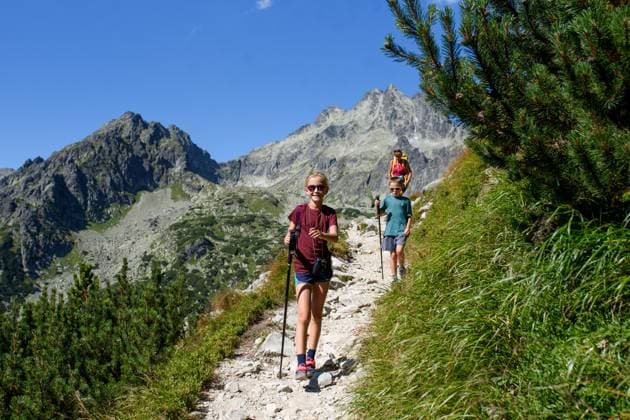 Grandmother with grandchildren on hike in autumn mountains. Kids spending summer break in nature with family. Grandmother with grandchildren on hike in autumn mountains. Kids spending summer break in nature with a family. model released
