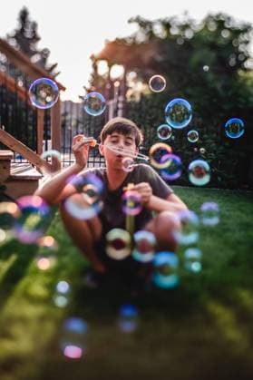 Creative Highlights Symbolfotos Young teen boy blowing soap bubbles outdoors on sunny day. Kingston, Ontario, Canada CR_DOHO240911-1503623-01 ,model released, Symbolfoto