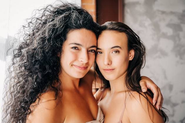 Creative Highlights Symbolfotos Two women with close smiles embrace in soft natural light Haverhill, Massachusetts, United States CR_FKNH240917-1543134-01 ,model released, Symbolfoto