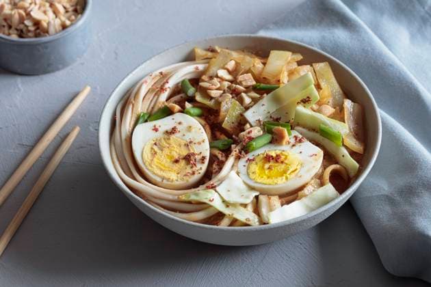 White cabbage soup with miso and udon noodles and boiled eggs and peanuts as topping, EVGF04475