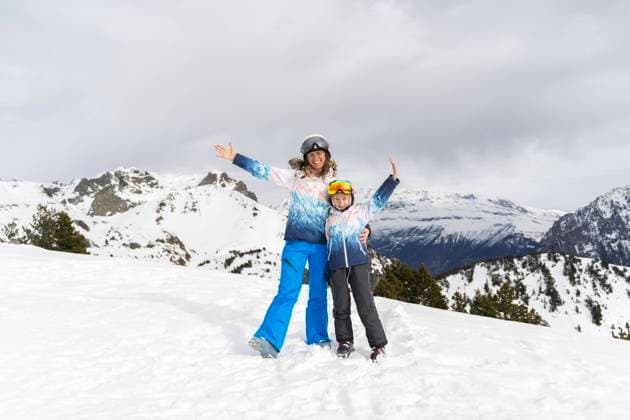 Happy mother and son standing with arms raised in front of mountains model released, Symbolfoto, NJAF01366