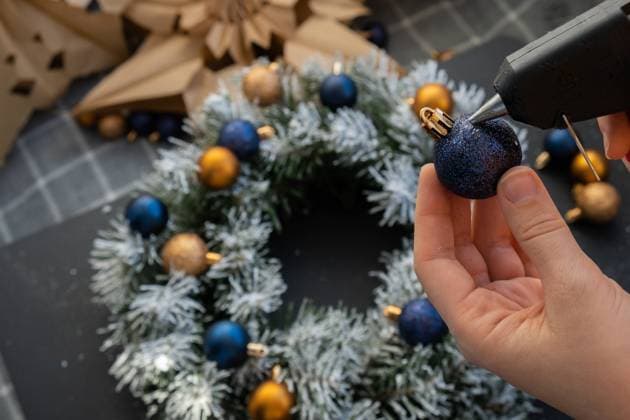 Crafter using hot glue DIY process of woman making Christmas arrangement with decor of blue and yellow colors. Small business, self employed entrepreneur, self-made career. Series of handmade craft instruction. Zero waste eco-friendly winter holiday decor Crafter using hot glue DIY process of woman making Christmas arrangement with decor of blue and yellow colors. Small business, self employed entrepreneur, self-made career. Series of handmade craft instruction. Zero waste eco-friendly winter holiday decoration. New year Copyright: xZoonar.com AnastasiiaxYanishevskax 22223083