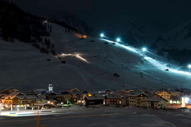 Ski village night scenario Ski village at night with slope lights, cross-country ski run, buildings, ice monument - shot in Livigno, Italian Alps Copyright: xZoonar.com FrankxGärtnerx 7532409