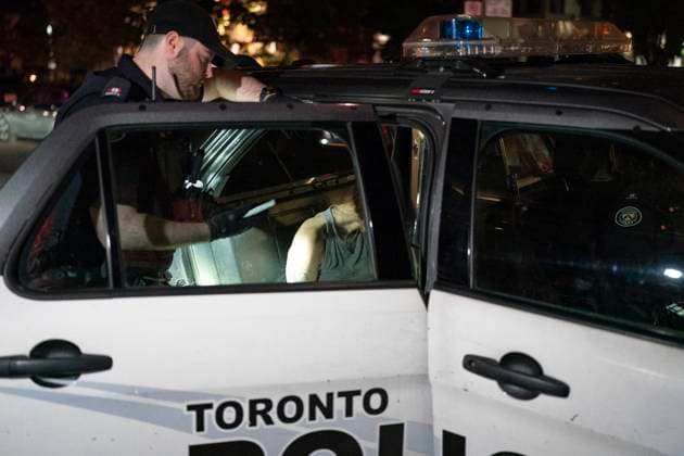 October 2, 2024, Toronto, On, Canada: Toronto Police take a person into custody at the scene where a police officer was shot, in Toronto, on Wednesday, Oct. 2, 2024. The officer was taken to hospital with life threatening injuries. Toronto Canada  - ZUMAc35_ 20241002_zaf_c35_128 Copyright: xArlynxMcadoreyx