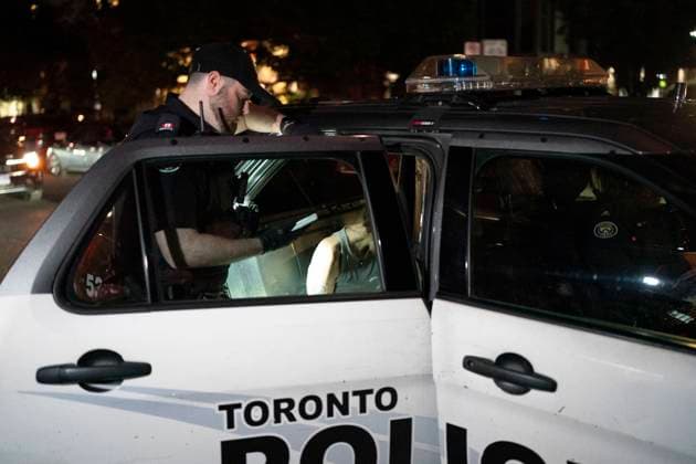 October 2, 2024, Toronto, On, Canada: Toronto Police take a person into custody at the scene where a police officer was shot, in Toronto, on Wednesday, Oct. 2, 2024. The officer was taken to hospital with life threatening injuries. Toronto Canada  - ZUMAc35_ 20241002_zaf_c35_129 Copyright: xArlynxMcadoreyx