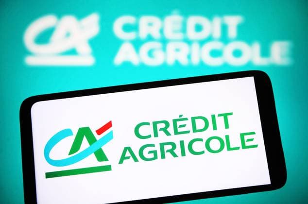 Illustration in Ukraine. In this photo illustration, the Credit Agricole logo is seen on a smartphone and in the background. Ukraine Copyright: xPavloxGoncharx xSOPAxImagesx PGONCHAR_9294