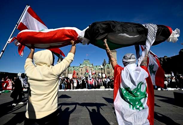 October 5, 2024, Ottawa, On, CAN: Sandbags symbolizing the bodybags of civilian casualties are held up as pro-Palestine demonstrators rally on Parliament Hill in Ottawa, on Saturday, Oct. 5, 2024. Ottawa CAN  - ZUMAc35_ 20241005_zaf_c35_129 Copyright: xJustinxTangx