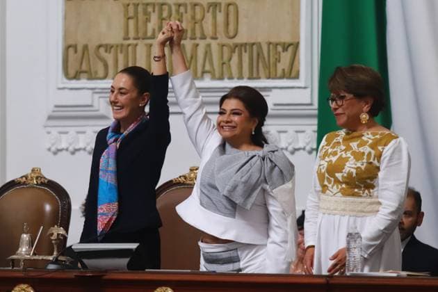 First female MexicoÃ¢â‚¬â ¢s President Claudia Sheinbaum Pardo lifts the hand of incoming Mexico City Head of Government Clara Brugada Molina during the swearing-in ceremony at the Congress of Mexico City. on October 5, 2024 in Mexico City, Mexico. Mexico City Mexico - ZUMAe321 20241005_zia_e321_082 Copyright: xCarlosxSantiagox