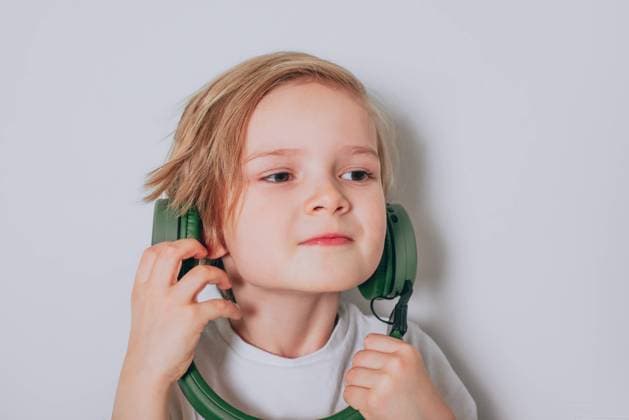 Creative Highlights Symbolfotos Amazed caucasian boy wearing headphones listening to music on a white Belarus, Mogilev Region, Belarus R_PJWUOI210901-817766-01 ,model released, Symbolfoto