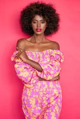 Creative Highlights Symbolfotos Confident African American female in trendy outfit Confident African American female in trendy outfit and with Afro hairstyle looking at camera while standing against pink background in studio ,model released, Symbolfoto Copyright: xZoonar.com DanielxDashx 19320807 ,model released, Symbolfoto ,property released