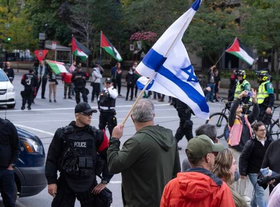 October 7, 2024, Montreal, Pq, Canada: Police keep a safe space between a small group of Palestinian supporters and a pro-Israel vigil on the anniversary of a Hamas attack on Israel that triggered the ongoing war in Gaza in front of McGill University, in Montreal, Monday, Oct. 7, 2024. Montreal Canada  - ZUMAc35_ 20241007_zaf_c35_043 Copyright: xRyanxRemiorzx