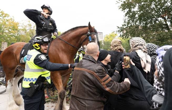 October 7, 2024, Montreal, Pq, CANADA: Pro-Palestinian demonstrators are met by police as they march onto McGill campus on the anniversary of a Hamas attack on Israel that triggered the ongoing war in Gaza, in Montreal, Monday, Oct. 7, 2024. Montreal CANADA  - ZUMAc35_ 20241007_zaf_c35_080 Copyright: xChristinnexMuschix