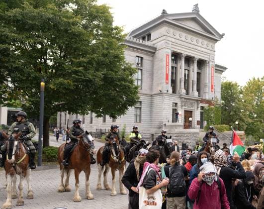 October 7, 2024, Montreal, Pq, CANADA: Palestinian supporters stand in front of mounted police as they march onto McGill University campus on the anniversary of a Hamas attack on Israel that triggered the ongoing war in Gaza, in Montreal, Monday, Oct. 7, 2024. Montreal CANADA  - ZUMAc35_ 20241007_zaf_c35_082 Copyright: xChristinnexMuschix