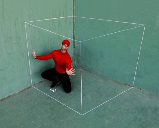 Creative Highlights Symbolfotos A middle-aged man dressed in red sitting inside a chalk-drawn box against a green wall, demonstrating a concept or a metaphorical idea Model Released SergioVictorVega_ID24274_703546_001 Copyright: xSergioxVictorxVegax RECORD DATE NOT STATED