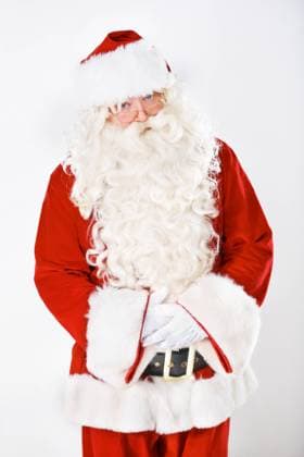 Portrait of father Christmas in studio with white background in a red costume for Christian winter holiday celebration. Marketing, senior or santa claus face with sales offer, promo or discount deals. model released property released Copyright: xwww.peopleimages.comx