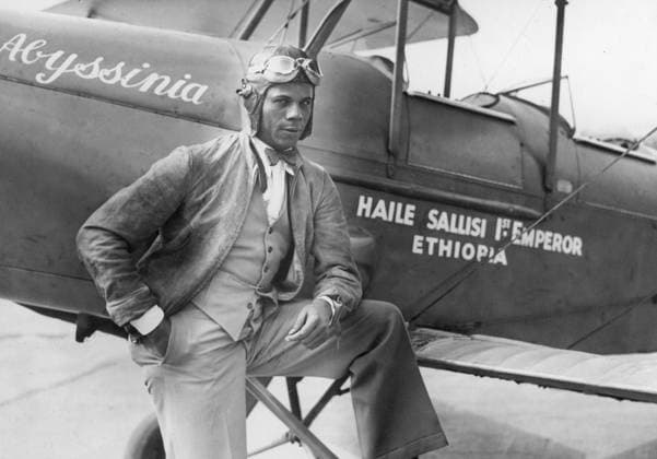Orig. caption... THE BLACK EAGLE OF HARLEM DEPARTS FROM PARIS Colonel Hubert Fauntleroy Julian, the Black Eagle of Harlem and one-time air minister of Ethiopia came back to Paris yesterday and found that the French capital had not forgotten him. He left shortly afterwards for England where he hopes to take part in the London-Melbourne air race. The Black Eagle was as debonair and confident as ever. The Photo shows Colonel Julian and his new English plane at Le Bourget. July 16, 1934 Note. See also BBX264 Abyssinia, Ethiopia H Julian, 1897-1983, West Indian-born aviator who was nicknamed The Black Eagle when in 1924 he made an unsuccessful attempt to fly from New York to Africa. In 1929, two years after Charles Lindbergh, he managed to fly a  Copyright: xx HUBERT JULIAN