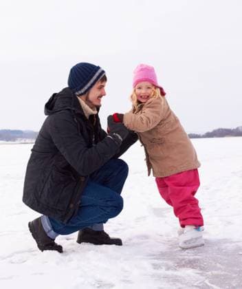 Father with daughter outdoor, learn to ice skate and fun in nature with snow, winter and people skating on frozen lake. Man have fun with girl child, teaching and learning with sports and recreation. model released property released Copyright: xx