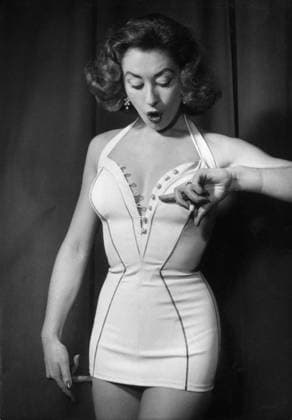 Orig. caption... ET DEJA L ON PRESENTE LES NOUVEAUX MODELES POUR L ETE 1955. On sait que s eloignant de plus en plus du Bikini et des Deux pieces, les maillots seront pour la next season, trÃ s HabillÃ s. Ils se feront pour la plupart en une piece, assez longs et a Jupe Tournante. Voici Claire presented by Melle Yolande Roy, Reine de Nice 1954. C est un maillot une piece au dÃ colletÃ cernÃ de petits boutons forming une bande de coquillages. Model Arabelle. Note Buttons Swimwear Nude Bare shoulders Earrings Nail polish Swimwear Peka CD471 persons: YOLANDE ROY sites: FRANCE sp_sw x5600x *** Orig caption AND ALREADY THE NEW MODELS FOR SUMMER 1955 ARE PRESENTED We know that, moving away more and more from the bikini and the two-piece, t  Copyright: xx THE LATEST SWIMWEAR FASHION