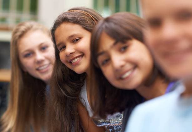 Girl, portrait and happy outdoor at school with confidence and pride for learning, education or knowledge. Student, person or face with smile in building or hallway before class or ready to study. model released property released Copyright: xPeopleImages.comx-x 524290fa88380x