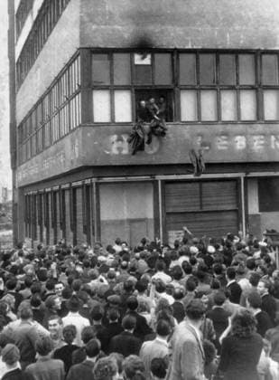 Orig. caption... PICTURE BY TELEPHOTO. MARTIAL LAW IN EAST BERLIN 17.6.53 Photo shows: East German police throw their uniforms out of the window of a state-owned department store in the East Berlin Zone this afternoon. The Russians declared martial law as 100,000 Germans rioted, tearing down the red flag and shouting We want to be Free. The police were besieged in the store and threw out their uniforms as a sign of surrender. Note Unrest Spectators CD604 sites: EAST GERMANY; EAST BERLIN sp_sw x5600x *** Orig caption PICTURE BY TELEPHOTO MARTIAL LAW IN EAST BERLIN 17 6 53 Photo shows East German police throw their uniforms out of the window of a state owned department store in the East Berlin Zone this afternoon The Russians declared marti  Copyright: xx 1953 EAST BERLIN Uprising