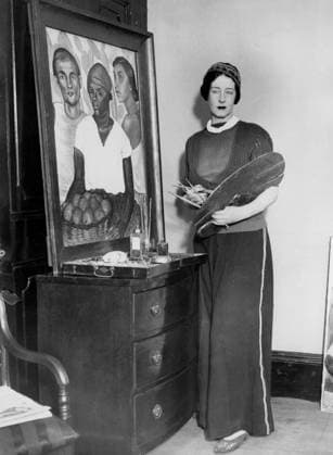 Orig. caption... GERMAN COUNTESS ARTIST WEARS TROUSERS WHILE WORKING IN LONDON STUDIO. An interesting foreign visitor to London is the Countess May Bernstorff, cousin of Count von Bernstorff of the German Embassy, who has come to London to give an exhibition of her paintings. She will be presented at one of the first courts. Her home is in Rio de Janeiro where she has been responsible for some notable portrait busts and fountains in addition to paintings. The Countess always works in her studio in wide trousers of red serge. Photo shows:- Countess May Bernstorff in her London studio where she is preparing for her exhibition. Feb 11th 1933. Note. Necklaces Trousers Lipsticks Painters Headbands Brushes Lapels Paintings Trio CD570 persons: MAY  Copyright: xx FEMALE ARTIST IN PANTS