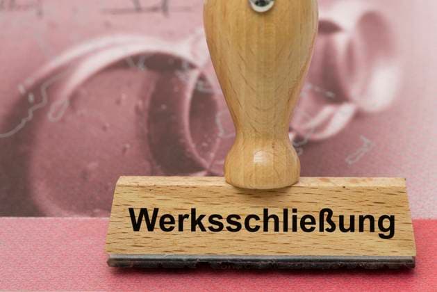 AUDI-Krise mit Gefahr der Werksschließung Ein Holzstempel ist beschriftet mit dem Aufdruck: Werksschließung, über einer AUDI-Aktie - Symbolbild *** AUDI crisis with risk of plant closure A wooden stamp is labeled with the words plant closure, above an AUDI share Symbolic image
