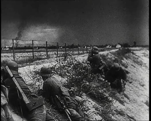 RECORD DATE NOT STATED Four Male German Army Soldiers Lying Low on a Slope Below a Fence While Columns of Smoke Rise from a Line of Trees in the Distance Behind Several Houses, 1939. From Time To Remember - The Reluctant Warriors, 1939 ( Reel 3); documentary about events of 1939 - preparations for war and then hostilities break out. Copyright:xBritishxPathexLtd HeritagexImagesxBritishxPathexLtdx IMAGO, ! ACHTUNG: AUFNAHMEDATUM GESCHÄTZT!  Copyright:BritishxPathexLtd HeritagexImagesxBritishxPathexLtdx IMAGO