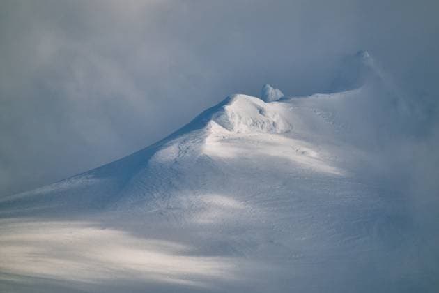 Creative Highlights World Frozen rocky mountain under foggy sky at twilight Hellissandur, Snæfellsbær, Iceland CR_OSBJ240924-1522716-01