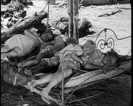 RECORD DATE NOT STATED Barefoot Female Children Sleeping On a Bedframe Outside, 1932. USA. On the land, things don t go so well. Because of ruthless timber-felling and unplanned agriculture, precious topsoil had been blown or washed away from millions of acres. In the middle west, a new and fearful name: the Dust Bowl. To the bad prices of a sagging market are added drought and failure. For as the land dies, so too dies all that men live by. Cattle, crops, the very roots of life. Only one thing to do - pack up and go. They called them Okies - displaced farmers, migrant workers. Westward they went in search of work, just as their forefathers had done in the old days. And so they moved on, or waited and hoped, existing only on the Grapes of Wrath . From Time To Re  Copyright:BritishxPathexLtd HeritagexImagesxBritishxPathexLtdx IMAGO
