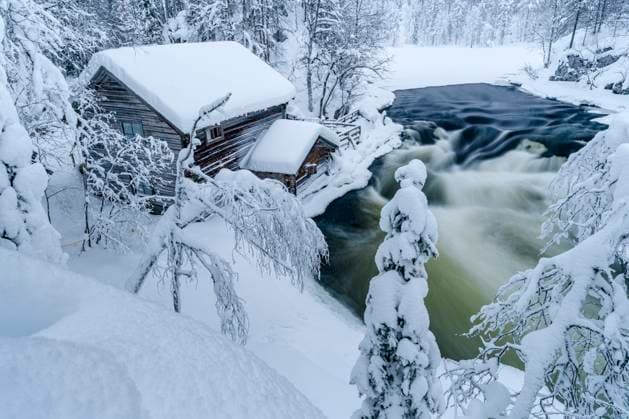 Snowy mountain hut in a forest by icy river rapids, Lapland, Finland Myllykoski, Kymenlaakso, Finland CR_ROMO2407090F-1472548-01
