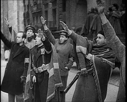 RECORD DATE NOT STATED Armed Men and Civilians Making Fascist Salutes in a Street in Madrid, All Dressed in Thick Coats and Two With Blankets Draped Around Their Shoulders, 1939. From Time To Remember - The Reluctant Warriors, 1939 (Reel 1); documentary about events of 1939 - preparations for war and then hostilities break out. Copyright:xBritishxPathexLtd HeritagexImagesxBritishxPathexLtdx IMAGO, ! ACHTUNG: AUFNAHMEDATUM GESCHÄTZT!  Copyright:BritishxPathexLtd HeritagexImagesxBritishxPathexLtdx IMAGO