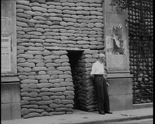 RECORD DATE NOT STATED A Man Standing Outside the Frontage of a Building Obscured By Sandbags Next To an Ornamental Gate, 1937. Spanish Civil War. ...there was - alas - plenty of trouble...at large in Europe, particularly in places like Madrid. For the cities of Spain were the first to feel the breath of war in a truly modern manner. It has been said that war is but an extension of politics. True enough, particularly if it happens to be a civil war...Sandbags, air-raid shelters, the constant threat of sudden death . From Time To Remember - Sense Of Values, 1937 (Reel 2); documentary film about the events of 1937, war in the Far East, build up to war in Europe. Copyright:xBritishxPathexLtd HeritagexImagesxBritishxPathexLtdx IMAGO, ! ACHTUNG: AUFNAHMEDATUM GESC  Copyright:BritishxPathexLtd HeritagexImagesxBritishxPathexLtdx IMAGO