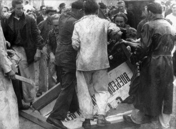 Orig. caption... RUSSIANS DECLARE MARTIAL LAW IN EAST ZONE BERLIN. 17.6.53. PHOTO SHOWS. East Berliners trample Russian signs underfoot during the rioting in the East Zone of Berlin this afternoon. The Russians declared martial law after 100,000 Germans rioted, tearing down the Red Flag, and parading the streets shouting We want to be free. Note The popular uprising in East Germany on June 17, 1953 started as a protest against a government decision to increase working hours. See also BAJ668 and BAJ680-BAJ681 Image series Photo report Riots Cyrillic text Riots Political opposition Signs State of emergency CD614 sites: EAST GERMANY; EAST BERLIN sp_sw x5600x *** Orig caption RUSSIANS DECLARE MARTIAL LAW IN EAST ZONE BERLIN 17 6 53 PHOTO SHOW  Copyright: xx Uprising in East Berlin