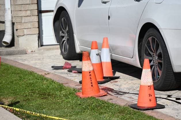 October 20, 2024, Markham, Canada: An evidence marker highlighting blood, flip flops and a gold chain that was found at the crime scene is present in Markham. The York Regional Police Homicide Unit are seeking suspects after a man was fatally shot in his driveway in the City of Markham. Saturday evening, after approximately 6:30 p.m. police responded to the area of 14th Avenue and McCowan Road. When officers arrived on scene, they located a man who has been identified as 44-year-old Partheepan Panchalingam from Markham suffering from gunshot wounds in the driveway of his residence. The victim was pronounced dead at the scene. Investigators are looking for at least one suspect, wearing dark clothing, who was seen in the area at the time, as - ZUMAs197 20241020_aaa_s197_269 Copyright: xKylexMazzax