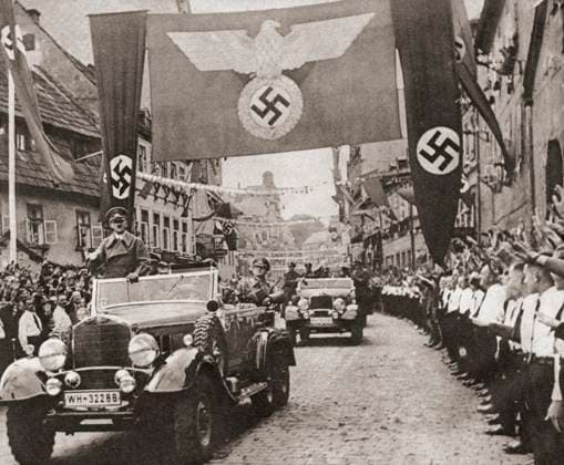 RECORD DATE NOT STATED Adolf Hitler. Adolf Hitler, on a victory drive, crossing the frontier from Germany into the Nazi Sudetenland districts of Czechoslovakia, October 3, 1938. Adolf Hitler,1889 - 1945. German politician, demagogue, Pan-German revolutionary, leader of the Nazi Party, Chancellor of Germany, and Fuhrer of Nazi Germany from 1934 to 1945. From These Tremendous Years, published 1938. Copyright: KenxWelshx xDesignxPics 902_05_13259734HighRes