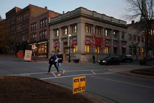 October 21, 2024, Saint John, Nb, Canada: Voters walk past a voting sign for the New Brunswick provincial election at a polling location in Saint John, N.B., Monday, Oct. 21, 2024. Saint John Canada  - ZUMAc35_ 20241021_zaf_c35_095 Copyright: xDarrenxCalabresex