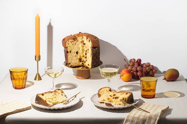 Beautifully arranged dessert table with Panettone, grapes, and sparkling wine, capturing the essence of Xmas holiday feasts Model Released OlgaVila_ID24397_707340_001 Copyright: xOlgaxVilax