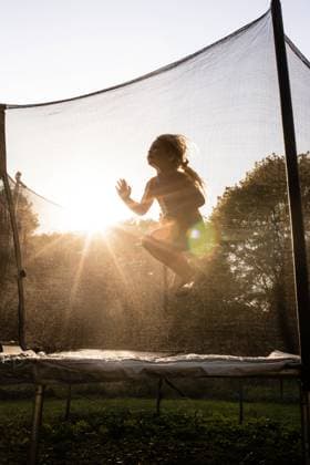 Creative Highlights Symbolfotos Child jumping on trampoline in golden light with sun rays McClure, Illinois, United States CR_WEKW241014-1560200-01 ,model released, Symbolfoto