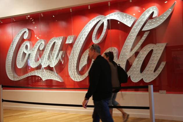 (241023) -- ATLANTA (U.S.), Oct. 23, 2024 -- Visitors walk past a Coca-Cola logo at the World of Coca-Cola in Atlanta, Georgia, the United States, on Oct. 23, 2024. Coca-Cola shares fell nearly 2 percent on Wednesday after the company reported weaker-than-expected third-quarter unit case volumes. ) U.S.-ATLANTA-COCA-COLA-Q3-EARNINGS LiuxYanan 