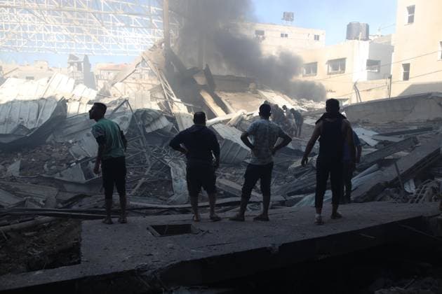 (241024) -- GAZA, Oct. 24, 2024 -- People gather at a destroyed building after an Israeli airstrike in the Al-Maghazi refugee camp, central Gaza Strip, on Oct. 24, 2024. The Palestinian death toll from ongoing Israeli attacks in the Gaza Strip has risen to 42,847, Gaza-based health authorities said in a statement on Thursday. (Photo by Xinhua) MIDEAST-GAZA-AL-MAGHAZI REFUGEE CAMP-ISRAEL-AIRSTRIKE MarwanxDawood 