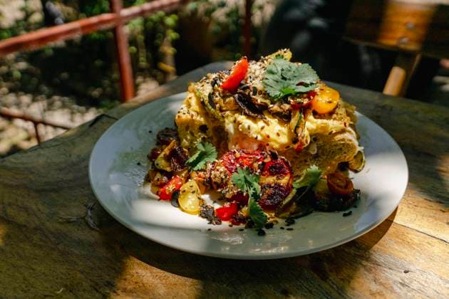 A beautifully plated Salvadoran dish, topped with fresh herbs and garnished with grilled vegetables, captures the essence of Central American cuisine. Model Released Almuzambrana_ID24112_698301_024 Copyright: xAlmuzambranax RECORD DATE NOT STATED