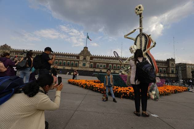 Persons taking photos of the Mega Ofrenda featuring monumental cardboard skeletons at the main square Zocalo as part of the Mexican Dia de Muertos festivities. on October 31, 2024 in Mexico City, Mexico. Mexico City Mexico - ZUMAe321 20241031_zia_e321_057 Copyright: xIanxRoblesx