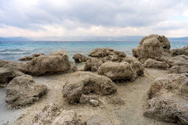 Creative Highlights World Scenic View of Rocky Shoreline at Lake Salda, Turkey Breathtaking landscape of Lake Salda s rocky shoreline, resembling a Martian terrain with vibrant blue waters under an overcast sky in Turkey. Copyright: xZoonar.com ArpanxBhatiax 22183569