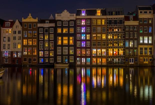 Dancing Houses on the Amsterdam Canal at Night Netherlands. Authentic canal houses in Amsterdam at night Copyright: xZoonar.com MikexPavlovx 17857012