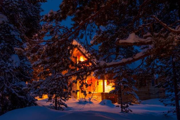 Snowy Pine Branches on a Background of Lighted Forest Cottage Evening winter forest. Pine branches covered with large caps of snow. Lighted cottage in the background Copyright: xZoonar.com MykhailoxPavlovx 16275970