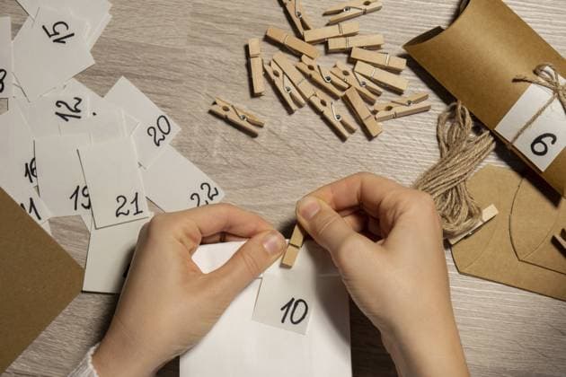 Unbekannte junge Frau klebt Nummer auf Basteltüte, befestigt mit Wäscheklammer. Weibliche Herstellung Kraftpapier für hausgemachte Adventskalender mit Ihren eigenen Händen Schritt für Schritt DIY Handwerk tun Sie es selbst gemacht. Vorbereitung auf Weihnachten Konzept. Saisonale Aktivitäten für Kinder Familie Winterferien. Umweltfreundliche Geschenke Geschenke. öffnen Sie das Paket jeden Tag Unrecognizable young woman sticks number on craft bag, fastens with clothespin. Female making kraft paper for homemade advent calendar Made with your own hands step by step DIY crafts do it yourself. Preparation to christmas concept. Seasonal activities for children family winter holidays. Eco friendly presents gifts. open the package every day Copyright: imageBROKER AnastasiiaxYanishevs ibxiqx11316988.jpg