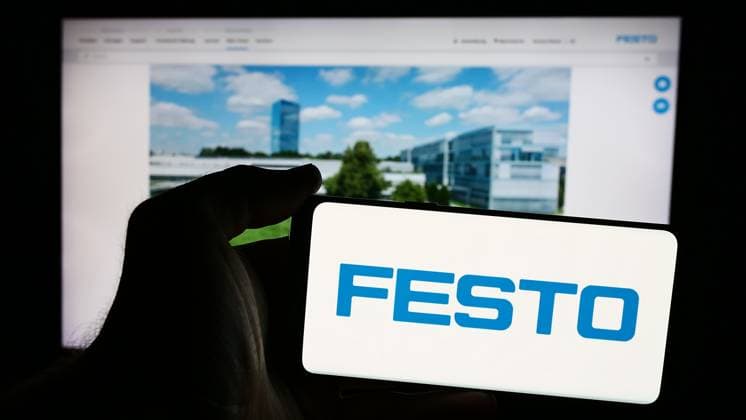 Person holding mobile phone with logo of German automation company Festo Beteiligungen GmbH Co. KG. Stuttgart, Germany - 08-06-2024: Person holding mobile phone with logo of German automation company Festo Beteiligungen GmbH Co. KG in front of web page. Focus on phone display. Copyright: xZoonar.com TimonxSchneiderx 22277074